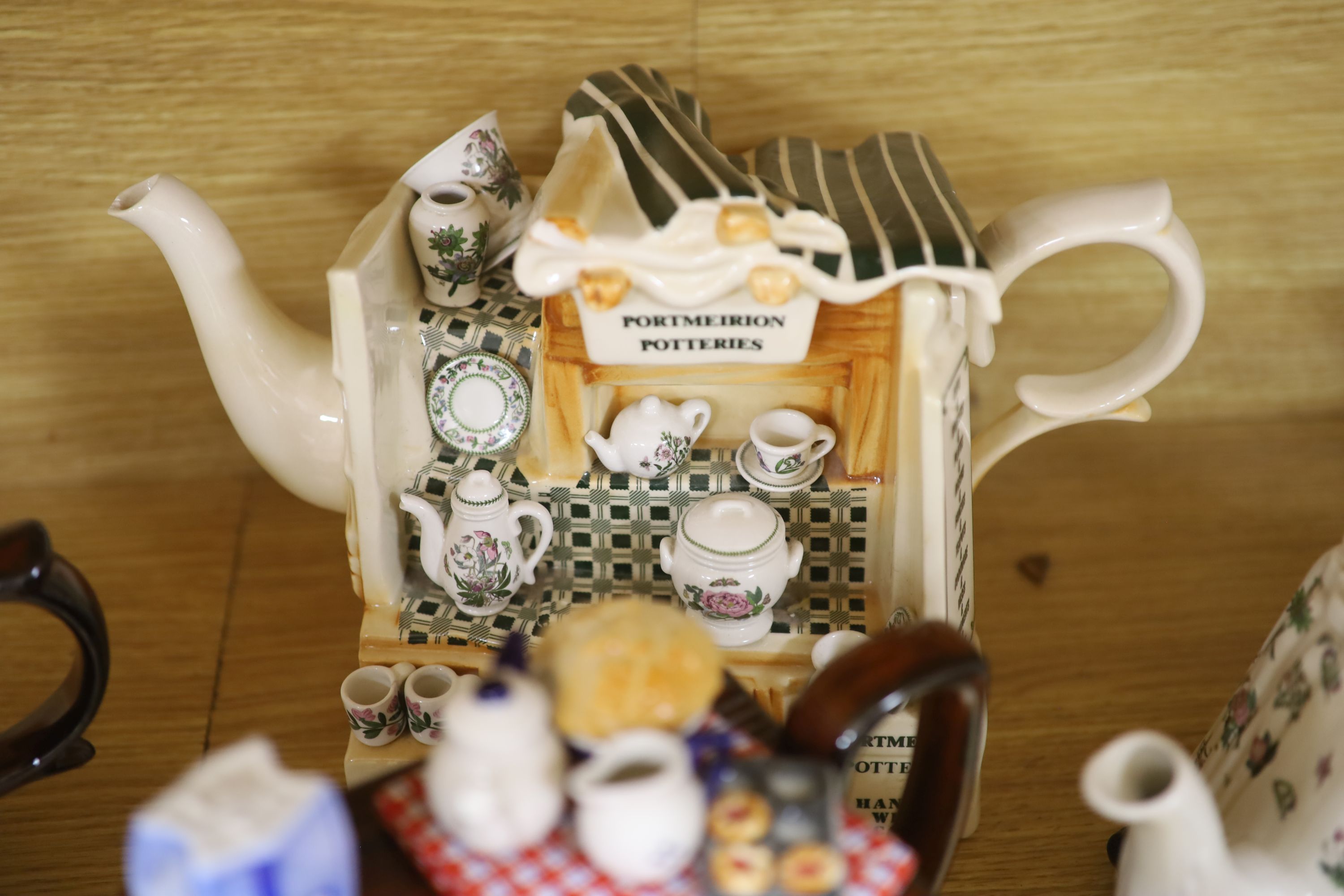 A collection of thirteen Portmeirion and Cardew novelty teapots, including dresser, sewing machine and kitchen range examples